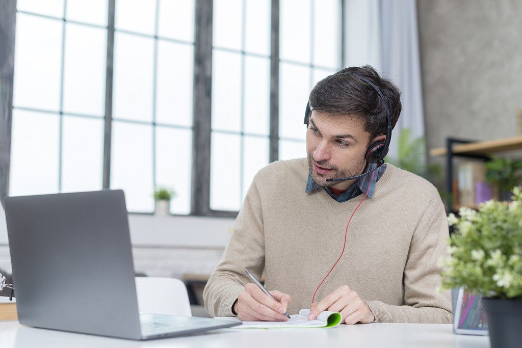 man with headphones having online meeting